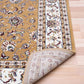 Berber-style area rug corner close-up, tan floral pattern with white ornamental border