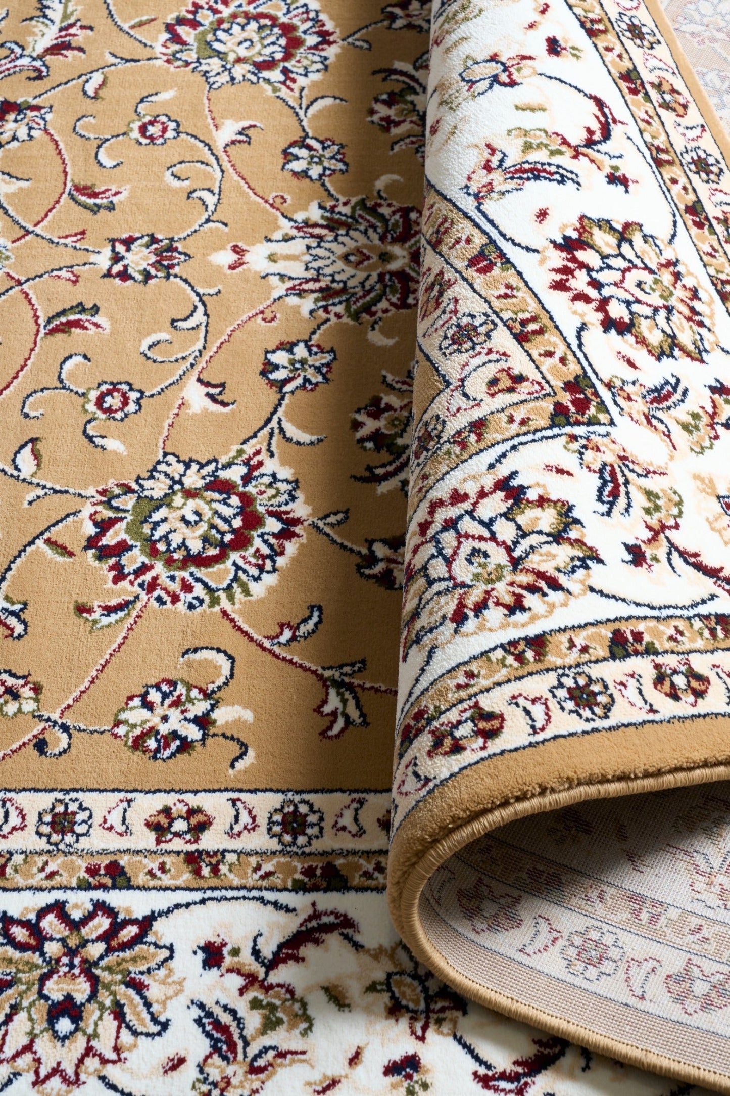 Berber-style rug fabric close-up with tan background, multicolor florals, and rolled edge