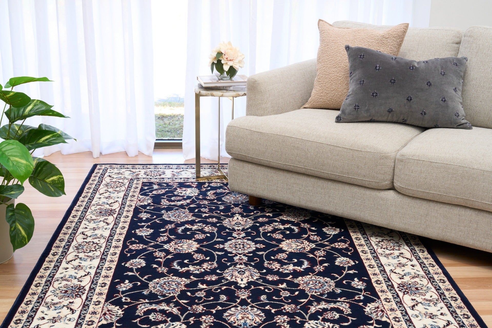BALUCHI navy area rug with floral vine motif and cream border stripes