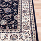 BALUCHI navy area rug with floral vine pattern, beige border and medallion panels