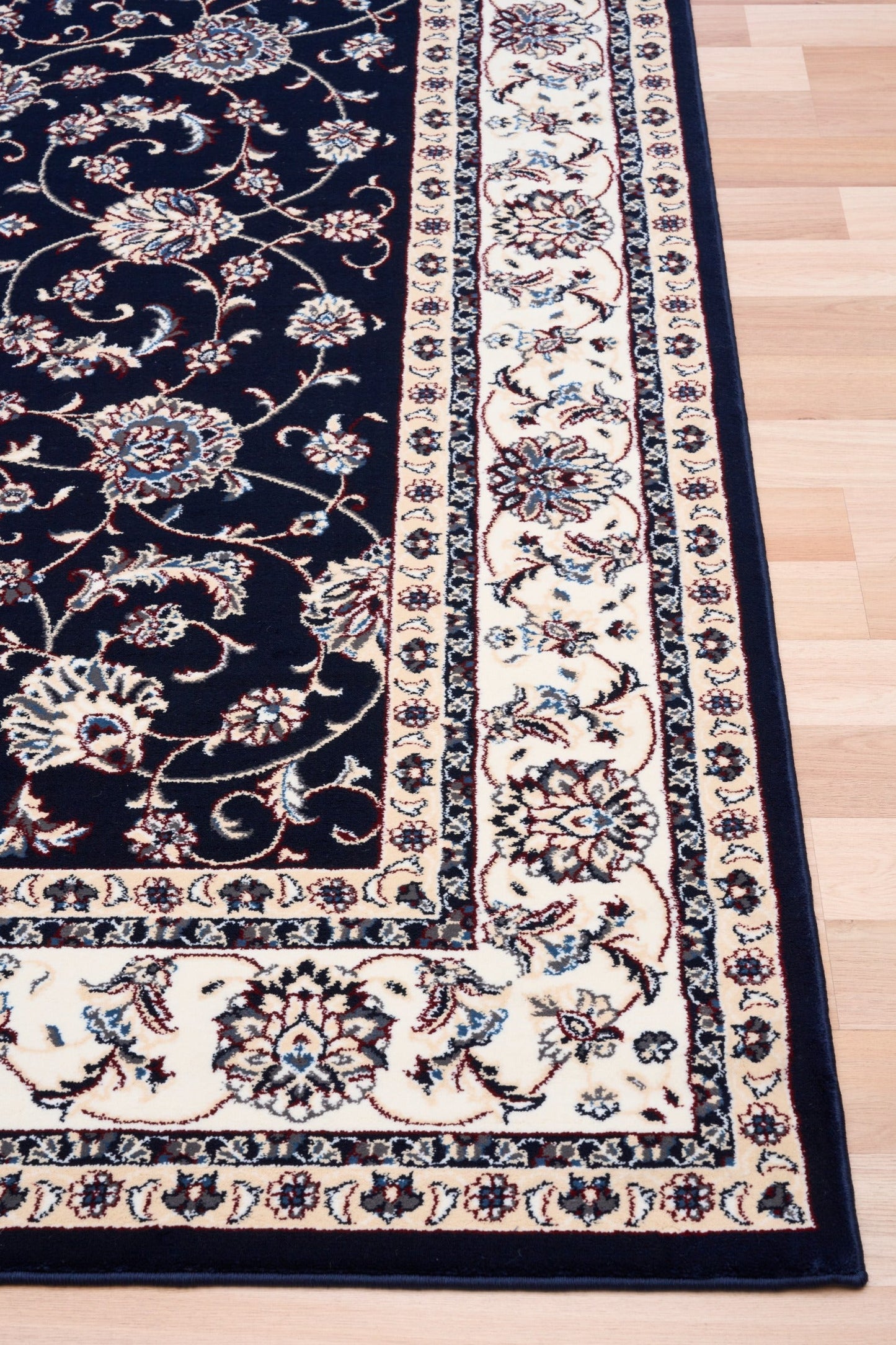 BALUCHI navy area rug with floral vine pattern, beige border and medallion panels