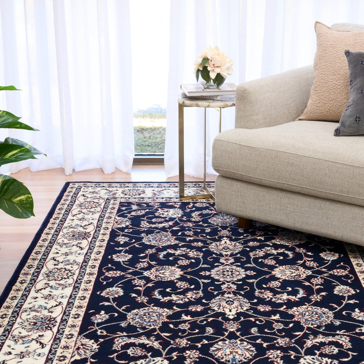BALUCHI navy area rug with decorative floral pattern and cream striped border