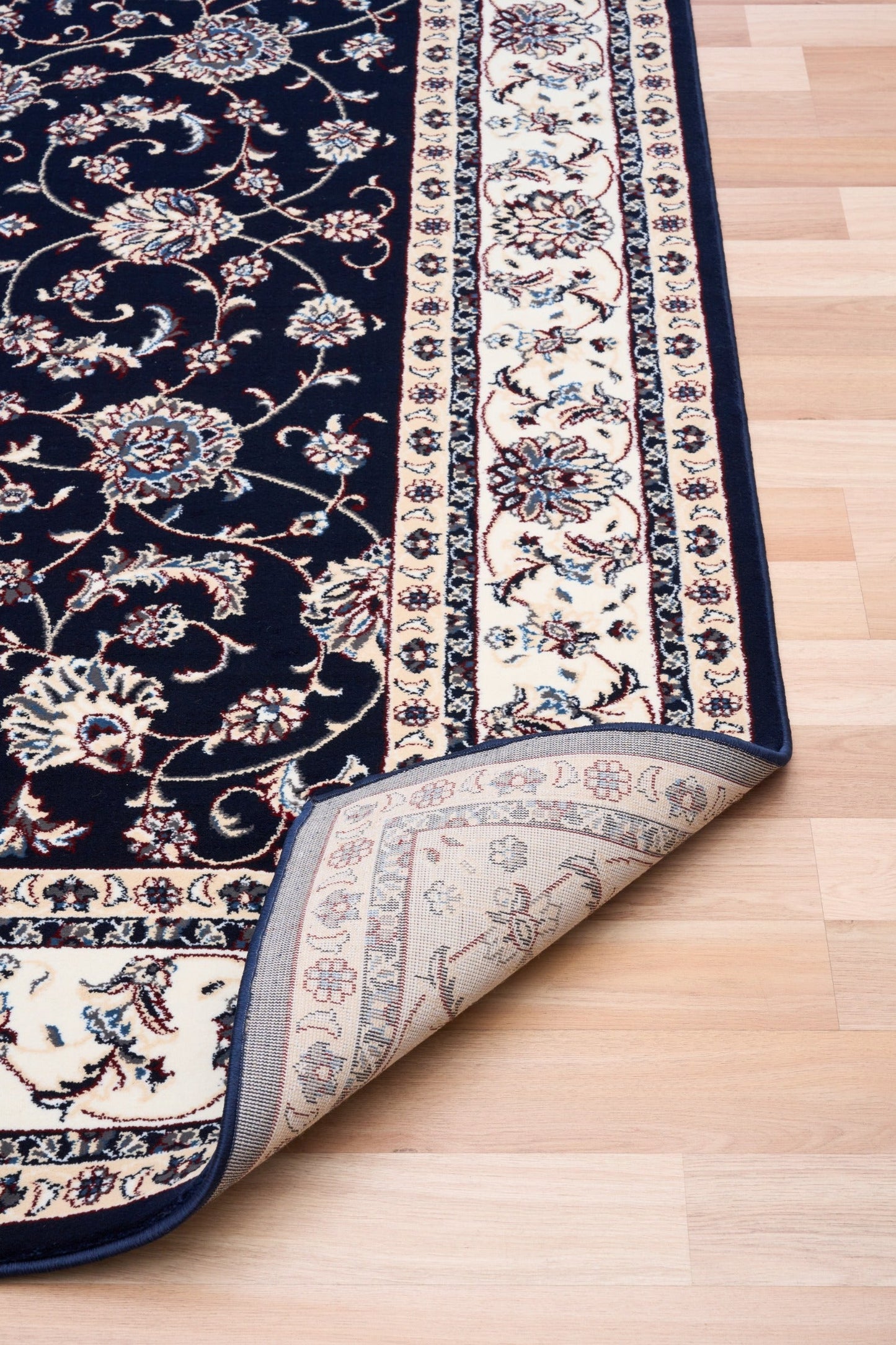 BALUCHI navy area rug showing folded edge and floral stripe border
