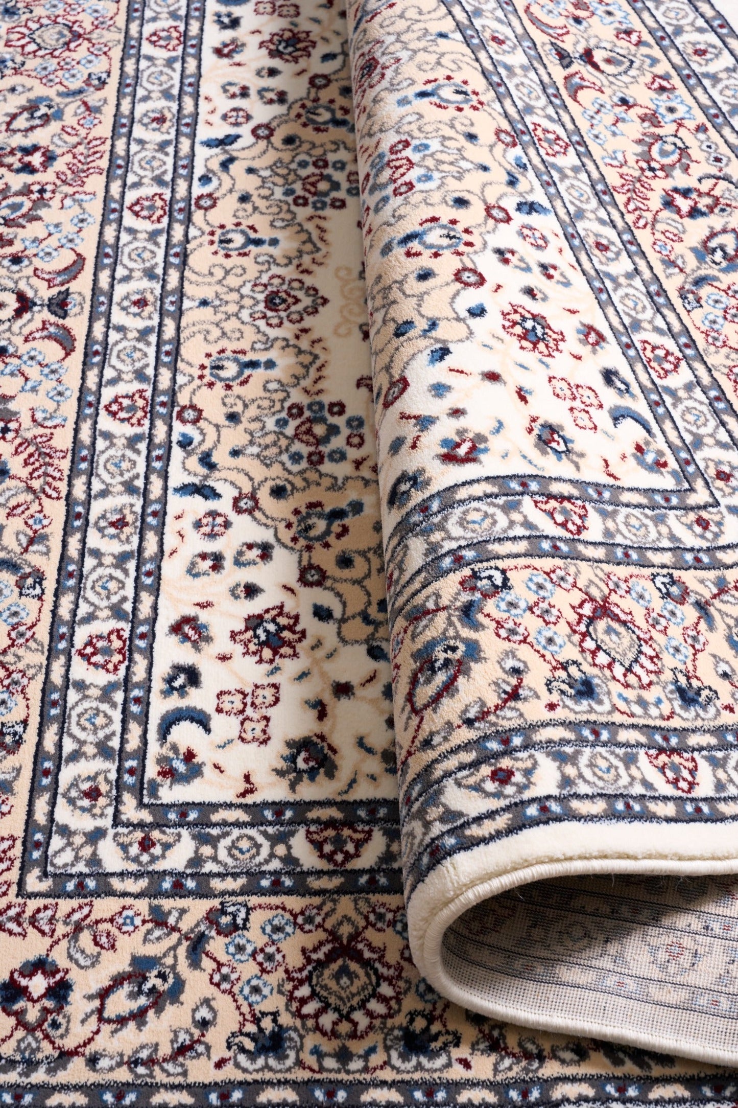 Ivory rug rolled edge showing underside weave and detailed border