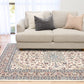 Ivory area rug with floral medallion pattern, blue border, and corner motifs
