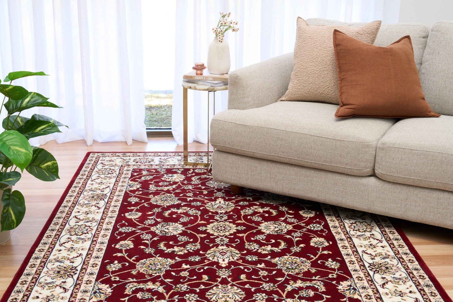 Burgundy floral area rug under a living room sofa, cream border visible | Baluchi Traditional floor Carpet Rug Vintage Traditional Floor Rug - Rugs Point Australia