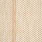 Textured woven rug close-up in light cream with repeating diamond lattice pattern.