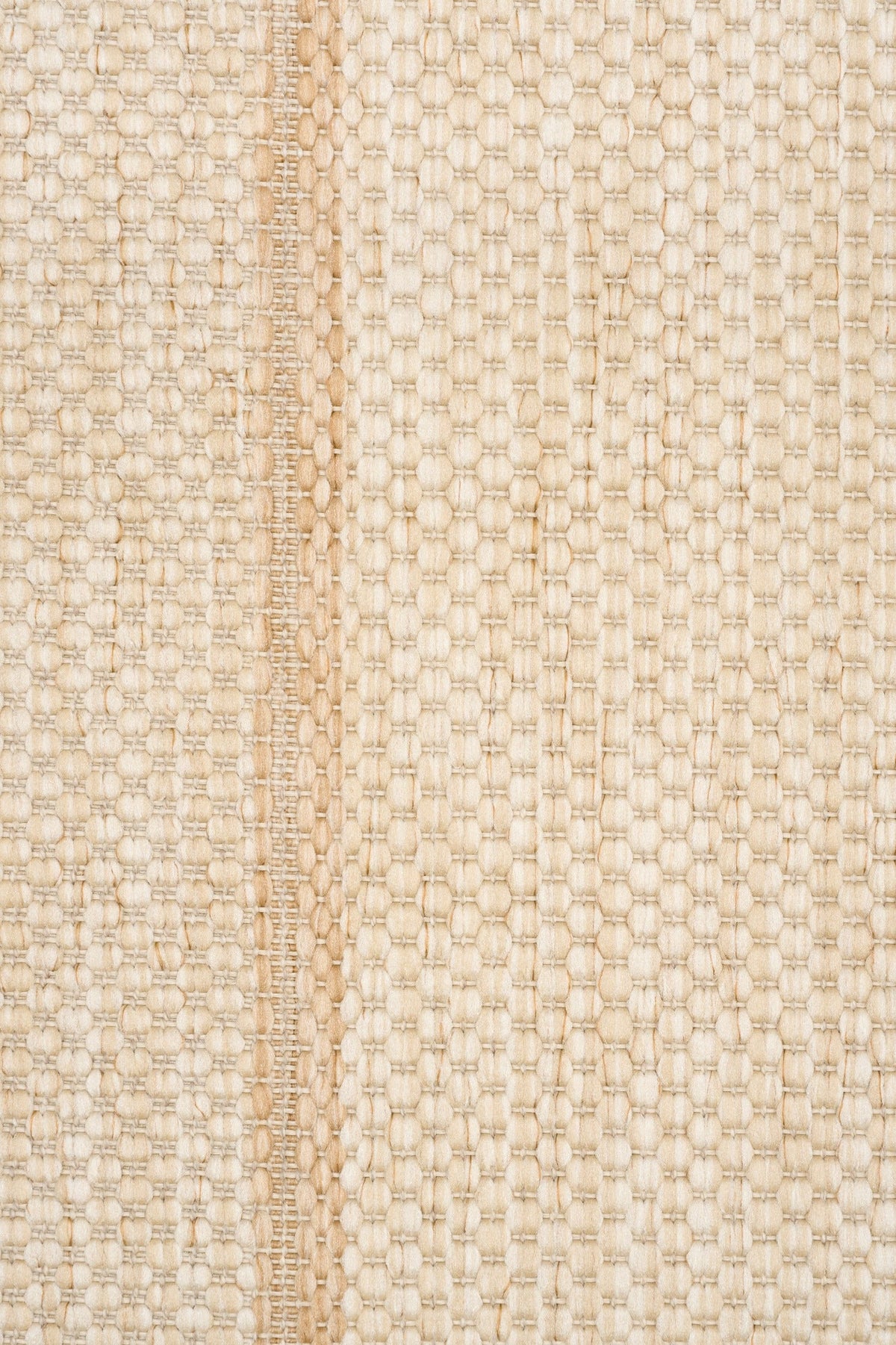 Textured woven rug close-up in light cream with repeating diamond lattice pattern.