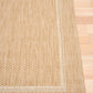 Beige flatweave area rug with border trim and inset square design
