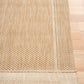 Beige textured area rug with visible edge binding and border trim