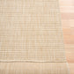 Beige woven area rug close corner view with textured striped grid and binding