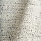 Cleo Blue textured area rug close-up, light blue speckled looped surface
