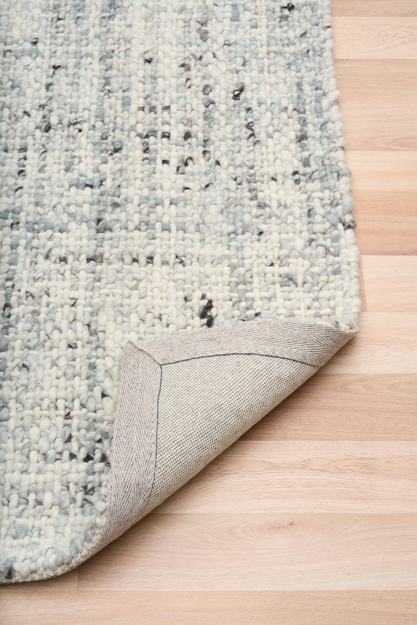 Cleo Blue textured area rug corner with light blue speckled pile and border
