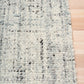 Cleo Blue textured area rug with light blue speckled weave and bound edge