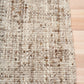 Wool area rug, beige with brown speckled weave and rounded edge