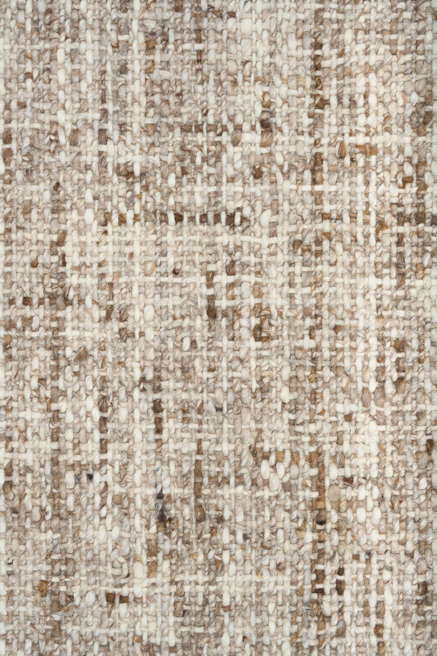 Wool rug surface close-up, beige base with brown and taupe flecks
