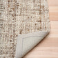 Wool rug with bound edge detail, beige underside on hardwood floor