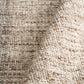 Wool rug corner detail, thick looped texture in beige and brown