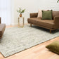 Ivory and light green textured area rug with dense speckled pattern