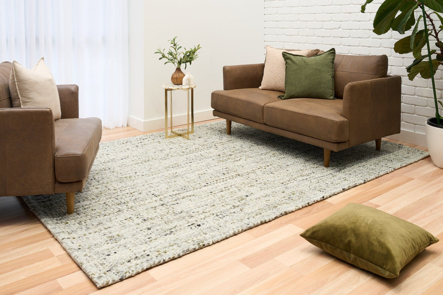 Ivory and light green textured area rug with dense speckled pattern