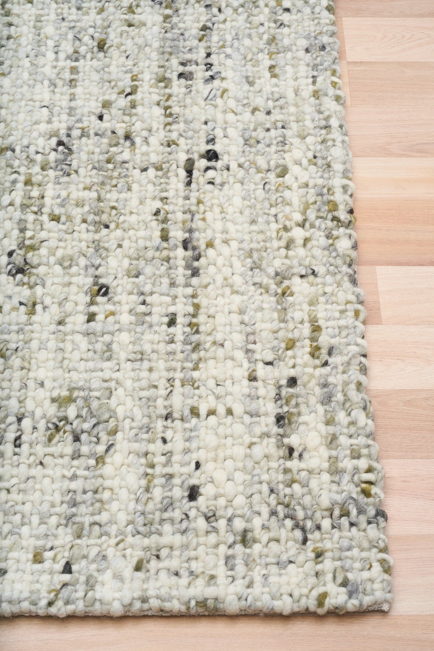 Cleo Green rug with cream, gray, and green speckled woven texture