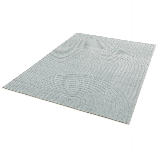 Light blue area rug with abstract wave lines pattern, flat lay view