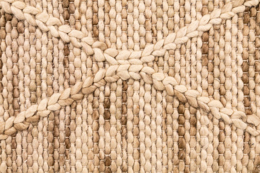 Natural wool rug textured beige looped weave with raised yarn pattern