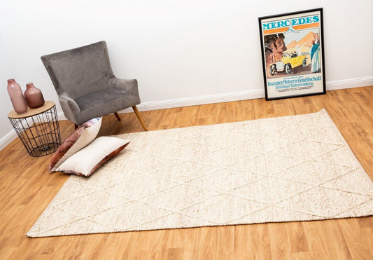 Beige wool rug with subtle diamond pattern and flat woven border