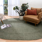 Olive green round area rug with low-texture woven surface