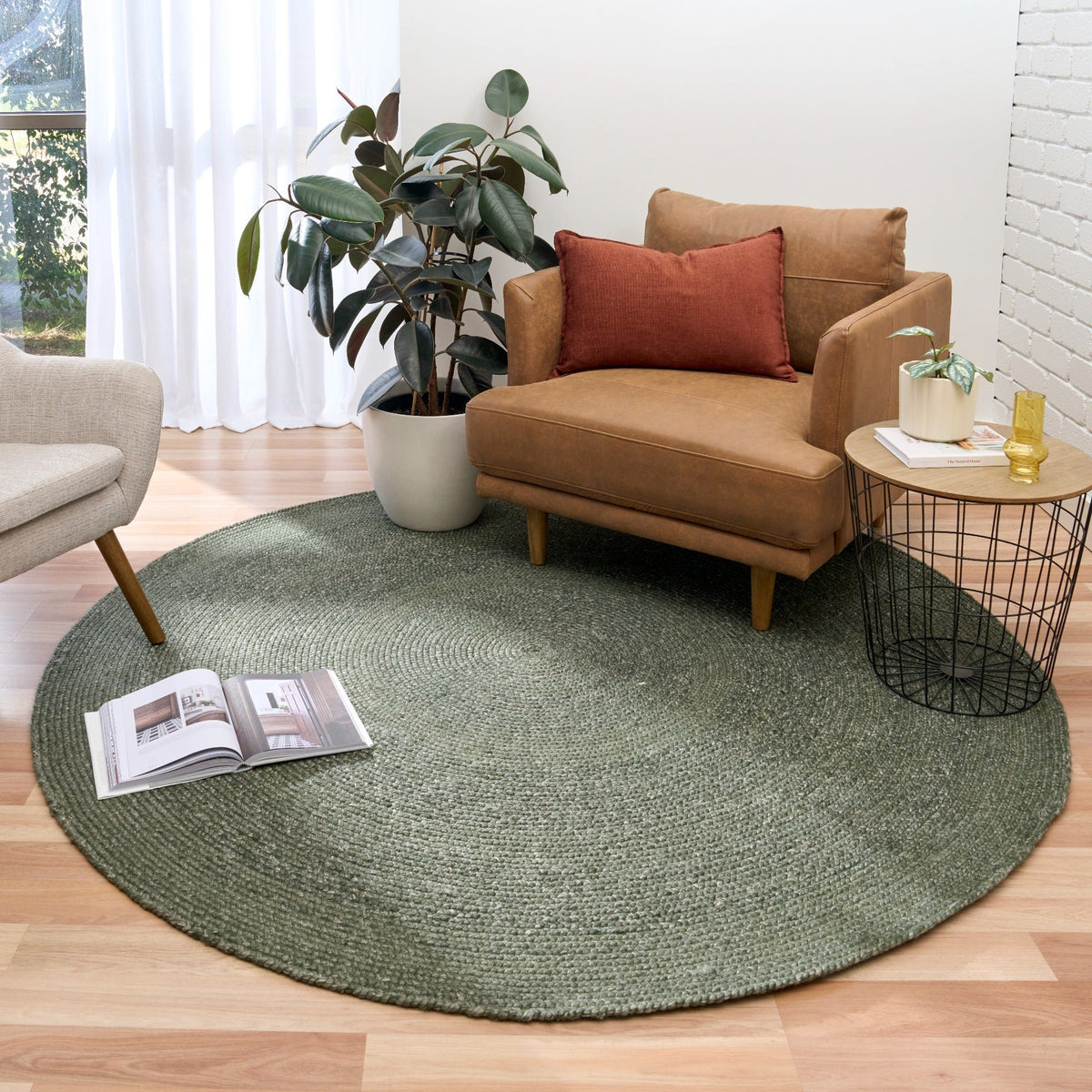 Olive green round area rug with low-profile woven texture, full view