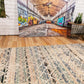 Blue and beige abstract area rug with textured lines and distressed pattern