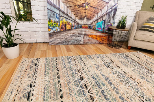 Blue and beige abstract area rug with textured lines and distressed pattern