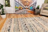Blue and beige abstract area rug with textured lines and distressed pattern