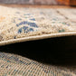 Rolled edge view of blue and beige rug with beige binding and low pile