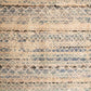 Blue and beige abstract striped rug with diamond and crosshatch details