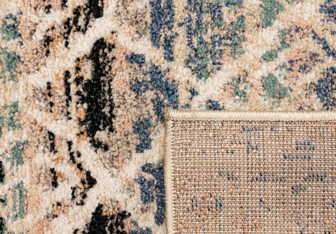 Corner detail of blue and beige rug showing textured pattern and woven border