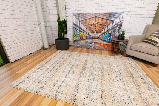 Ivory beige rug with distressed geometric pattern and subtle border