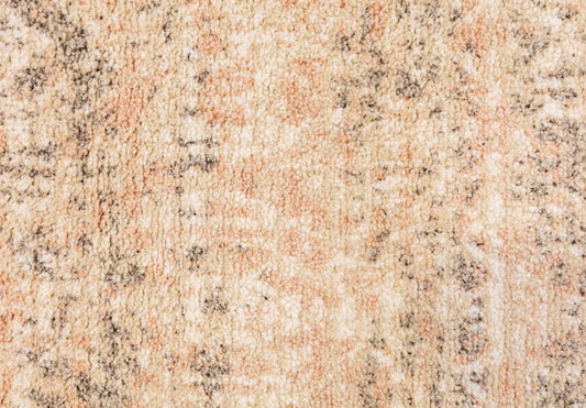 Beige and tan speckled rug with dense textured abstract design