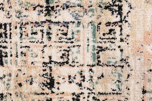 Ivory beige rug close-up with black and blue geometric embroidery-style pattern