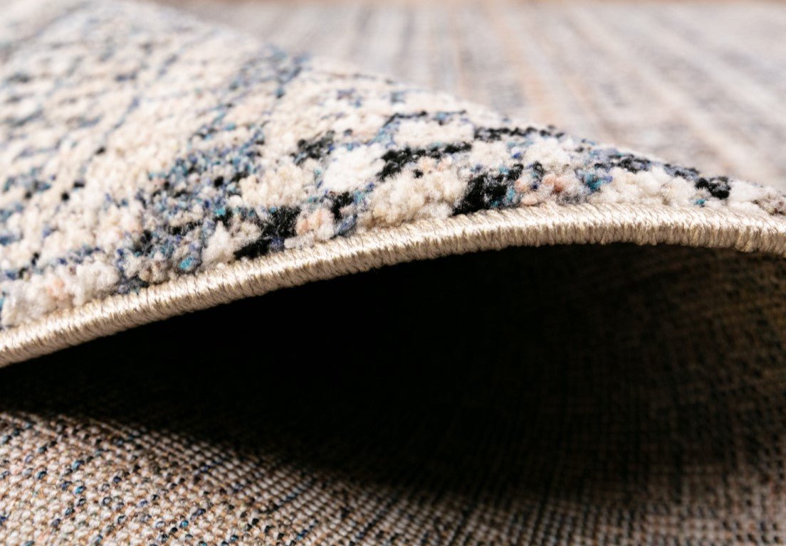Multicolor speckled area rug with stitched beige border and low-profile edge
