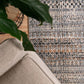 Ivory dark beige area rug with multicolor speckled pattern and flat woven texture