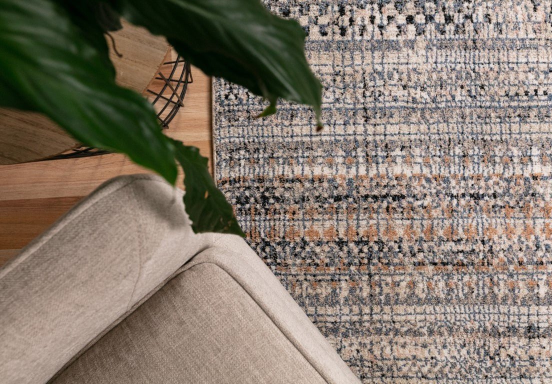 Ivory dark beige area rug with multicolor speckled pattern and flat woven texture