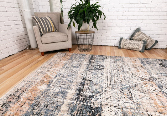 Ivory abstract area rug with blue and dark beige distressed pattern