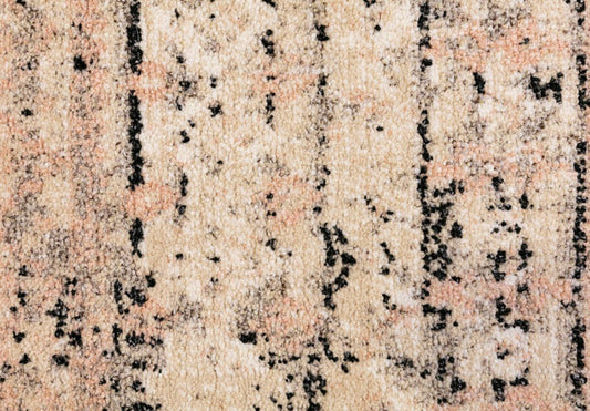 Cream rug with black speckled lines and geometric distressed motifs, plush textured pile