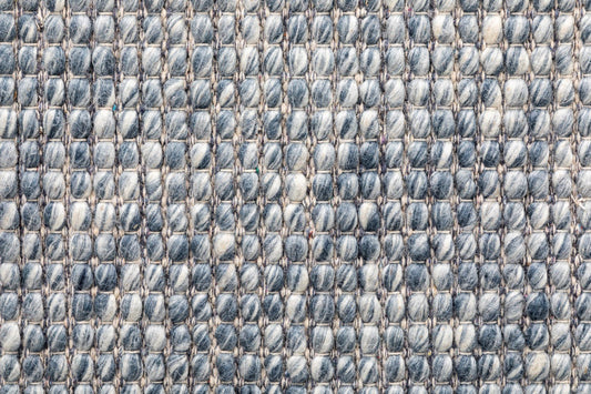 Wool rug weave close-up with light and medium blue-gray loop pattern