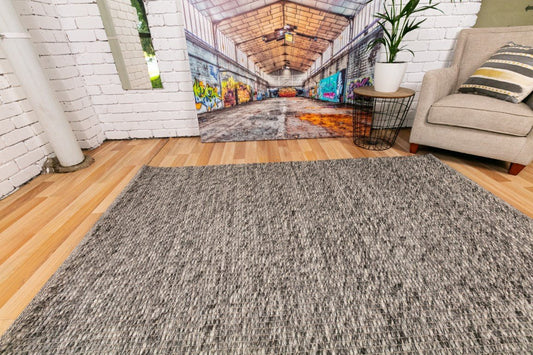 Dark grey wool area rug with dense woven texture and low, even pile