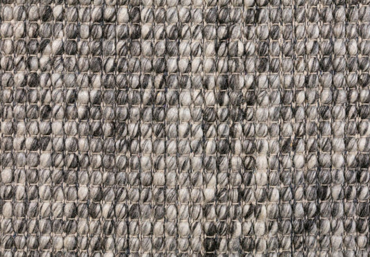 Close-up of dark grey and light grey woven wool rug texture
