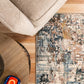 Abstract multi-color area rug on hardwood floor beneath neutral sofa