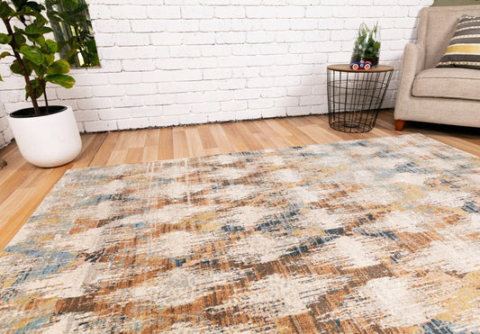 Abstract light beige area rug with blue and tan distressed texture