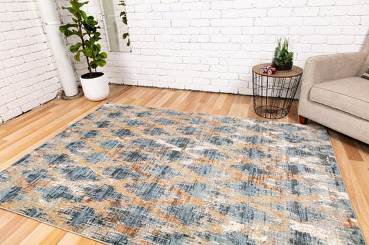 Modern area rug in a living room with blue, tan, and cream distressed design
